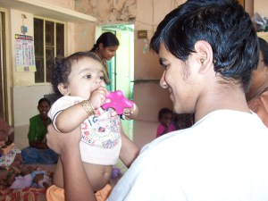 Me holding the boy in the orange shorts.